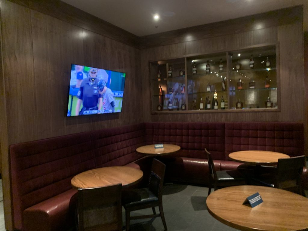 Multiple mounted televisions and installed lights in a restaurant and bar